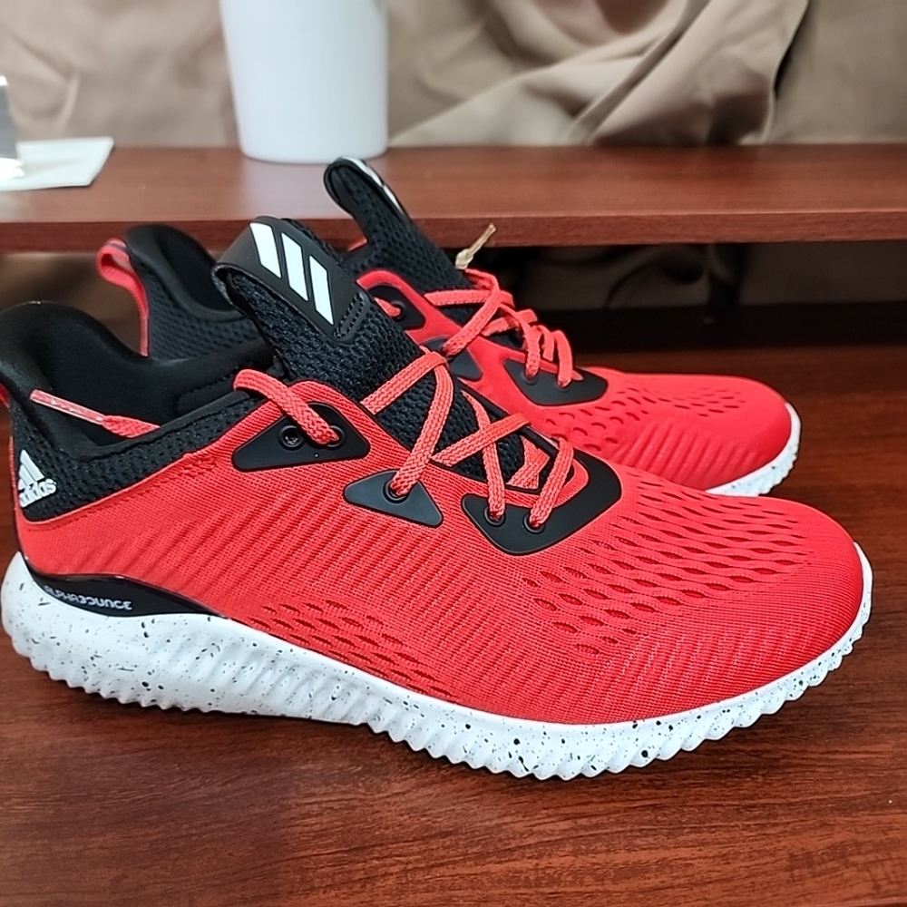 A pair of red and black addids